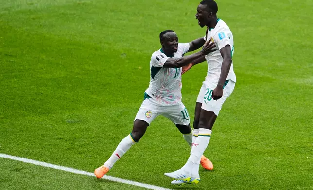 Senegal's Pape Gueye (26) celebrates with Sadio Mane after scoring the team's third goal during the World Cup Group I soccer match between Senegal and Iraq in Toronto, Friday, June 26, 2026. (AP Photo/Olivia White)