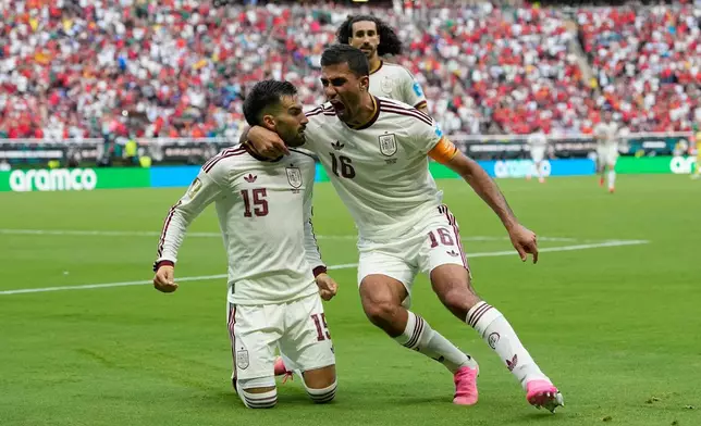 Spain's Alex Baena, left, is congratulated after scoring his side's opening goal by Rodri during the World Cup Group H soccer match between Uruguay and Spain in Zapopan, near Guadalajara, Mexico, Friday, June 26, 2026. (AP Photo/Natacha Pisarenko)