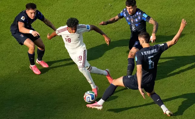 Spain's Lamine Yamal (19) controls the ball against Uruguay's Mathias Olivera (16), Rodrigo Bentancur (6) and Manuel Ugarte (5) during the World Cup Group H soccer match between Uruguay and Spain in Zapopan, near Guadalajara, Mexico, Friday, June 26, 2026. (AP Photo/Fernando Llano)