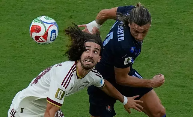 Spain's Marc Cucurella (24) battles for the ball with Uruguay's Agustin Canobbio (14) during the World Cup Group H soccer match between Uruguay and Spain in Zapopan, near Guadalajara, Mexico, Friday, June 26, 2026. (AP Photo/Fernando Llano)