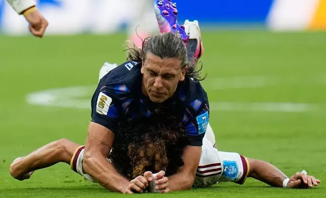 Uruguay's Agustin Canobbio, up, challenges for the ball with Spain's Marc Cucurella during the World Cup Group H soccer match between Uruguay and Spain in Zapopan, near Guadalajara, Mexico, Friday, June 26, 2026. (AP Photo/Ricardo Mazalan)