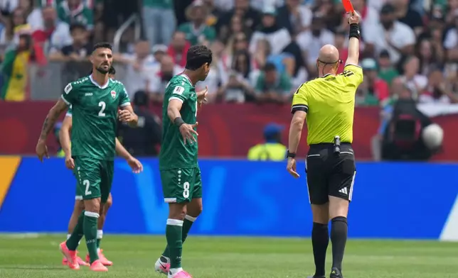 Referee Anthony Taylor, of the United States, right, issues a red car to Iraq's Rebin Ghareeb (2) during the World Cup Group I soccer match between Senegal and Iraq in Toronto, Friday, June 26, 2026. (AP Photo/Stephanie Scarbrough)