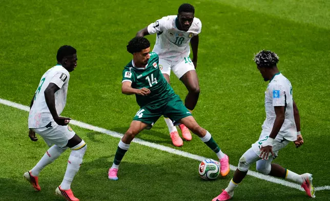 Iraq's Zidane Iqbal (14) controls the ball during the World Cup Group I soccer match between Senegal and Iraq in Toronto, Friday, June 26, 2026. (AP Photo/Olivia White)