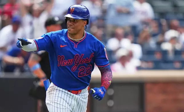 New York Mets' Juan Soto (22) gestures to teammates as he runs the bases after hitting a home run during the seventh inning of a baseball game against the St. Louis Cardinals Thursday, June 11, 2026, in New York. (AP Photo/Frank Franklin II)