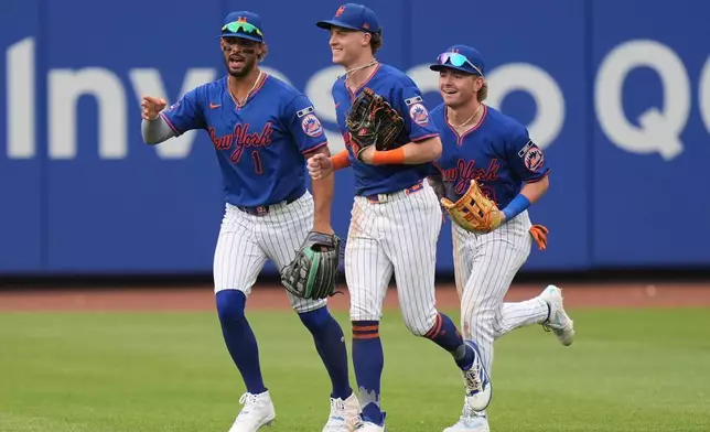 New York Mets outfielders Mj Melendez, left, Carson Benge, center, and A.J. Ewing celebrate after a baseball game against the Atlanta Braves, Sunday, June 14, 2026, in New York. (AP Photo/Seth Wenig)