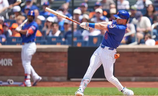 New York Mets' A.J. Ewing hits a two-run double during the first inning of a baseball game against the Atlanta Braves, Sunday, June 14, 2026, in New York. (AP Photo/Seth Wenig)