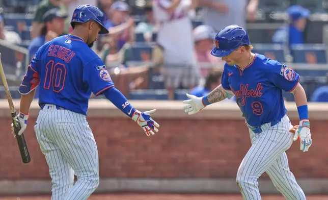 New York Mets' A.J. Ewing, right, celebrates his home run with Marcus Semien during the fifth inning of a baseball game against the Atlanta Braves, Sunday, June 14, 2026, in New York. (AP Photo/Seth Wenig)