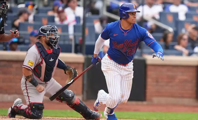 New York Mets' Juan Soto looks after his two-run single during the eighth inning of a baseball game against the Atlanta Braves, Sunday, June 14, 2026, in New York. (AP Photo/Seth Wenig)