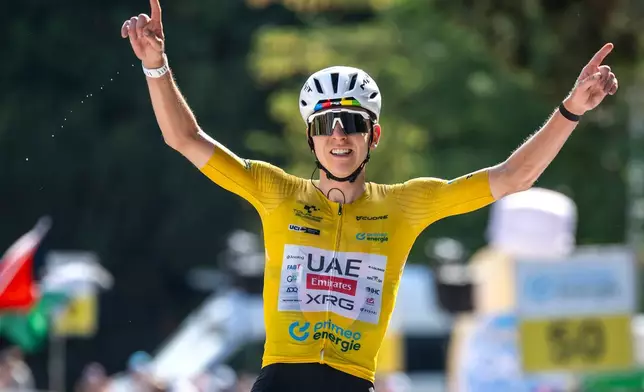 The winner of the stage Tadej Pogacar, of Slovenia, celebrates as he crosses the finish of the fifth and final stage, a 151 km race with start and finish in Villars-sur-Ollon, at the 89th Tour de Suisse UCI World Tour cycling race, Sunday, June 21, 2026. (Gian Ehrenzeller/Keystone via AP)