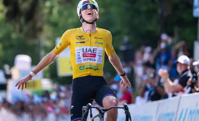 The winner of the stage Tadej Pogacar, of Slovenia, celebrates as he crosses the finish of the fifth and final stage, a 151 km race with start and finish in Villars-sur-Ollon, at the 89th Tour de Suisse UCI World Tour cycling race, Sunday, June 21, 2026. (Gian Ehrenzeller/Keystone via AP)