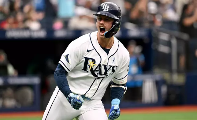 Tampa Bay Rays' Jonny DeLuca celebrates after his two-run home run as he rounds the bases during the seventh inning of a baseball game against the Washington Nationals, Sunday, June 21, 2026, in St. Petersburg, Fla. (AP Photo/Jason Behnken)