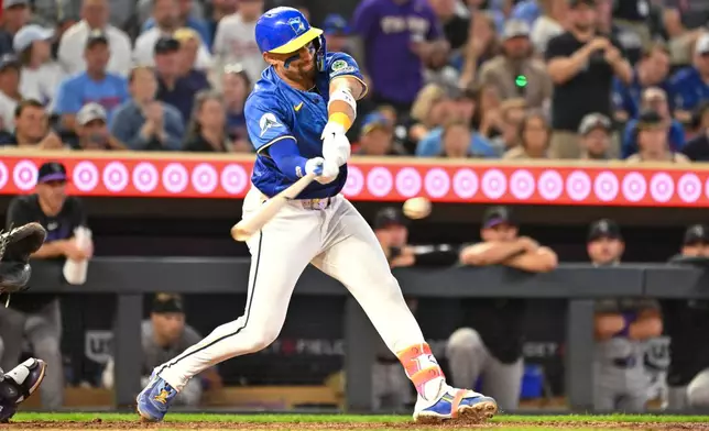 Minnesota Twins' Royce Lewis hits a walkoff single, scoring Kyler Fedko, against Colorado Rockies during the 10th inning of a baseball game Friday, June 26 2026, in Minneapolis. (AP Photo/Craig Lassig)