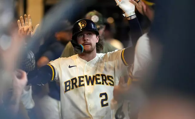 Milwaukee Brewers' Brice Turang is congratulated in the dugout after hitting a solo home run during the seventh inning of a baseball game against the Cincinnati Reds, Monday, June 29, 2026, in Milwaukee. (AP Photo/Aaron Gash)