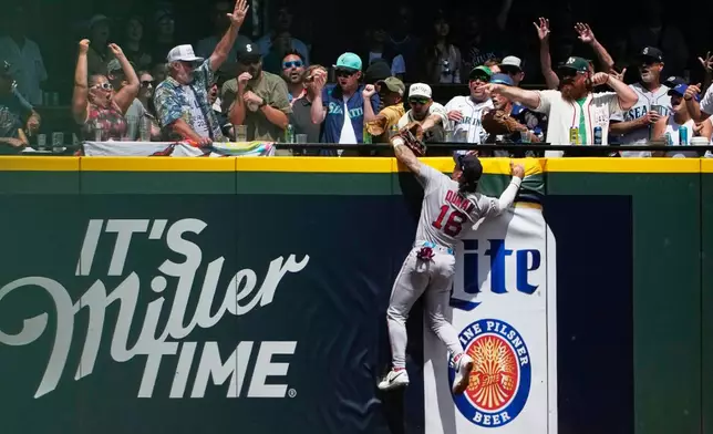 Boston Red Sox left fielder Jarren Duran can't get to the solo home run from Seattle Mariners' Dominic Canzone during the second inning of a baseball game, Sunday, June 21, 2026, in Seattle. (AP Photo/Lindsey Wasson)