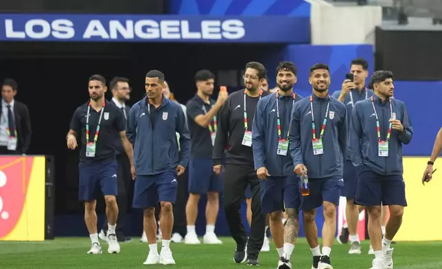 Iran players walk onto the pitch at the stadium one day before their FIFA World Cup match against New Zealand in Inglewood, Calif., near Los Angeles, Sunday, June 14, 2026. (AP Photo/Andre Penner)