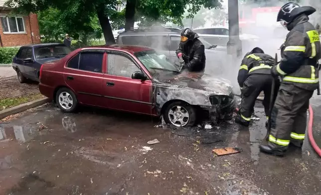 This photo provided by Moscow Region Governor Andrei Vorobyev's official telegram channel shows firefighters extinguish a burning car after a Ukrainian drone attack outside Moscow on Thursday, June 18, 2026. (Moscow Region Governor Andrei Vorobyev's official telegram channel via AP)