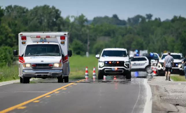 An emergency vehicle leaves the scene of the plane crash at the Butler Memorial Airport in Butler, Mo., Sunday, June 14, 2026. (AP Photo/Reed Hoffmann)