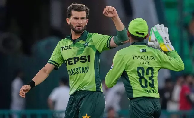 Pakistan's Shaheen Shah Afridi, left, celebrates with teammate after the dismissal of Australia's Cameron Green during the third one-day international cricket match between Pakistan and Australia, in Lahore, Pakistan, Thursday, June 4, 2026. (AP Photo/K.M. Chaudary)