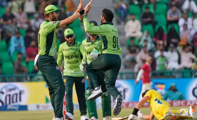 Pakistan's Arafat Minhas, centre, celebrates with teammates after the dismissal of Australia's Marnus Labuschagne, right, during the third one-day international cricket match between Pakistan and Australia, in Lahore, Pakistan, Thursday, June 4, 2026. (AP Photo/K.M. Chaudary)