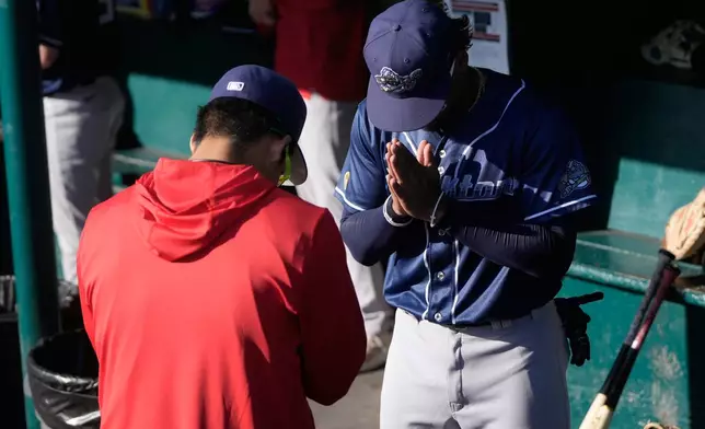 Stockton Ports' Shotaro Morii, left, and teammate Cesar Gonzalez bow to each other in the dugout before a Single A minor league baseball game against the San Jose Giants, May 20, 2026, in San Jose, Calif. (AP Photo/Jeff Chiu)