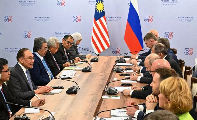 Russian President Vladimir Putin, fourth right, and Malaysian Prime Minister Anwar Ibrahim, second left, attend a talks on the sidelines of the Russia-ASEAN summit in Kazan, Russia, Wednesday, June 17, 2026. (Sergei Bobylev/Sputnik, Kremlin Pool Photo via AP)