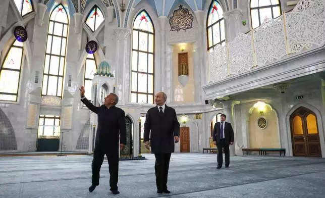 Russian President Vladimir Putin, center, and the head of the Republic of Tatarstan Rustam Minnikhanov, left, visit the Kul Sharif Mosque during the Russia-ASEAN summit in Kazan, Russia, Wednesday, June 17, 2026. (Mikhail Metzel/Sputnik, Kremlin Pool Photo via AP)