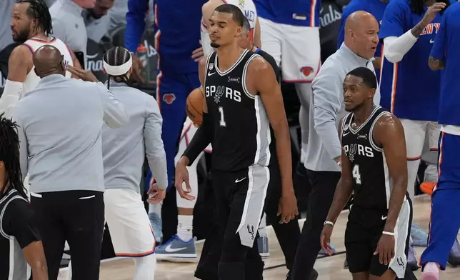 The San Antonio Spurs leave the court after Game 1 of the NBA Finals basketball series against the New York Knicks, Wednesday, June 3, 2026, in San Antonio. (AP Photo/Eric Gay)