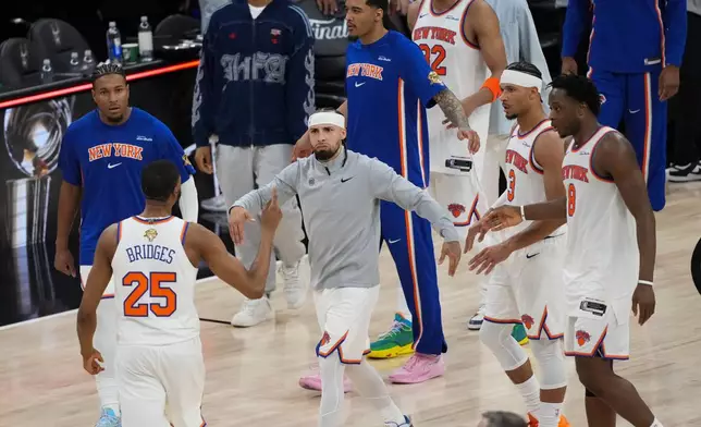 The New York Knicks celebrate after Game 1 of the NBA Finals basketball series against the San Antonio Spurs, Wednesday, June 3, 2026, in San Antonio. (AP Photo/Eric Gay)