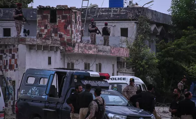 Paramilitary soldiers examine a damaged area after a militant attack at the provincial headquarters of the paramilitary Pakistan Rangers in Karachi, Pakistan, Sunday, June 28, 2026. (AP Photo/Ali Raza)