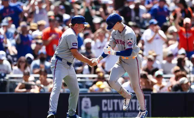 New York Mets' Carson Benge, right, is congratulated by third base coach Tim Leiper, left, as he rounds third after hitting a solo home run against the San Diego Padres in the sixth inning of a baseball game Sunday, June 7, 2026, in San Diego. (AP Photo/Derrick Tuskan)