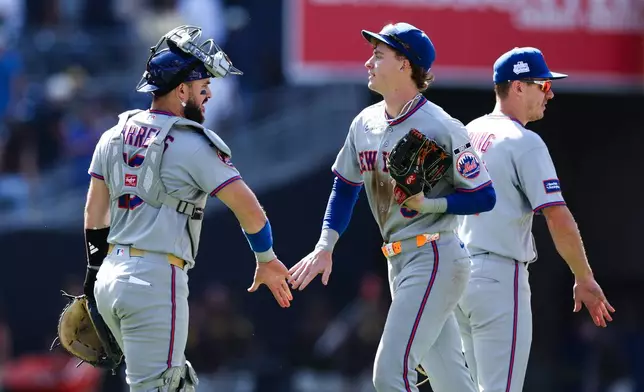 New York Mets' Carson Benge, center, celebrates with Luis Torrens, left, after their team defeated the San Diego Padres in a baseball game Sunday, June 7, 2026, in San Diego. (AP Photo/Derrick Tuskan)