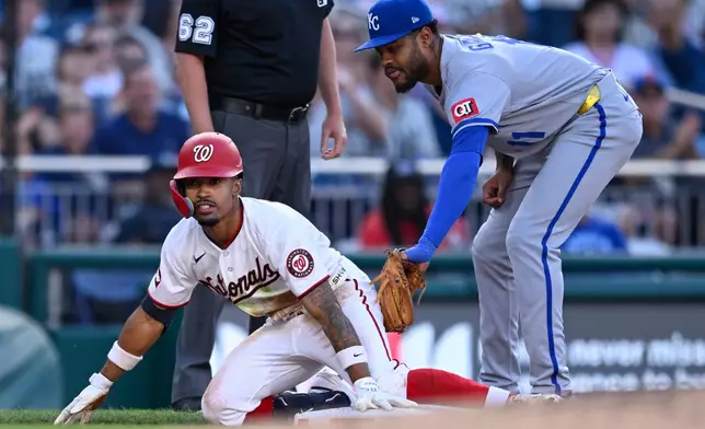 Washington Nationals's Nasim Nuñez beats the tag by Kansas City Royals third baseman Maikel Garcia for a RBI triple during the third inning of a baseball game, Tuesday, June 16, 2026, in Washington. (AP Photo/John McDonnell)
