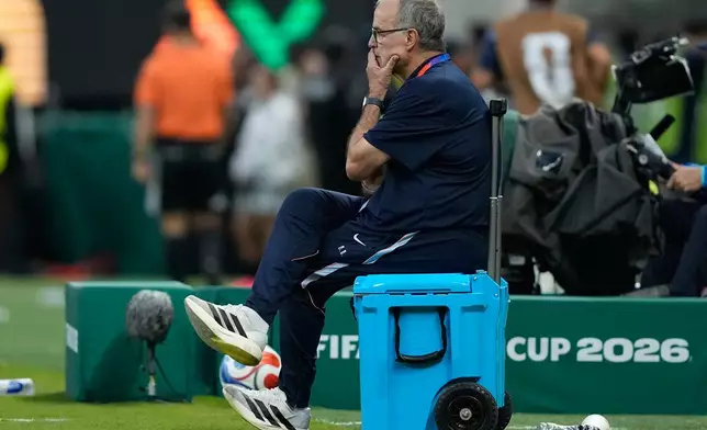 Uruguay head coach Marcelo Bielsa watches sits on a cooler during the World Cup Group H soccer match between Uruguay and Spain in Zapopan, near Guadalajara, Mexico, Friday, June 26, 2026. (AP Photo/Natacha Pisarenko )