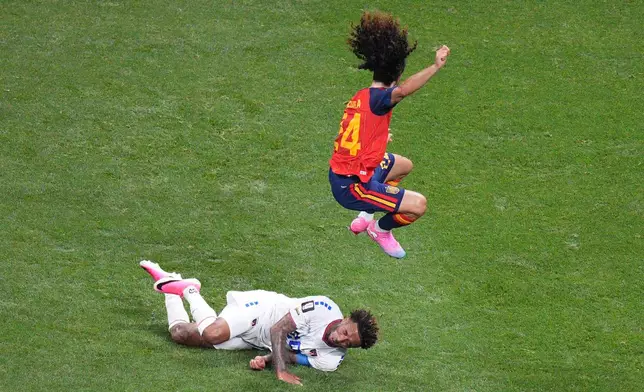 Spain's Marc Cucurella (24) jumps over Cape Verde's Ryan Mendes (20) during the World Cup Group H soccer match between Spain and Cape Verde in Atlanta, Monday, June 15, 2026. (AP Photo/Jacob Kupferman)