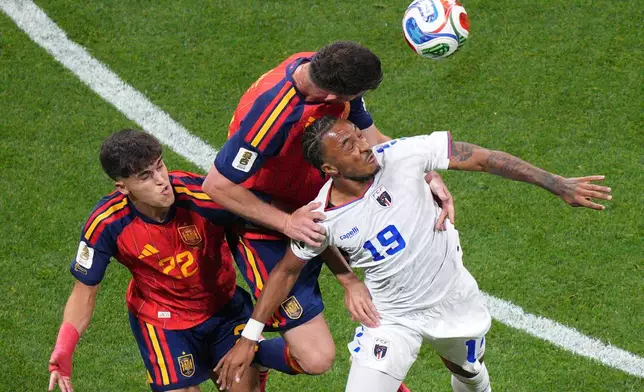 Spain's Aymeric Laporte (14) and Cape Verde's Dailon Livramento (19) go up for a header during the World Cup Group H soccer match between Spain and Cape Verde in Atlanta, Monday, June 15, 2026. (AP Photo/Jacob Kupferman)