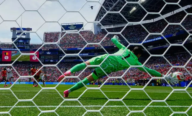 Belgium goalkeeper Thibaut Courtois (1) is beaten by a shot from Egypt's Emam Ashour (8) for the opening goal during the World Cup Group G soccer match between Belgium and Egypt in Seattle, Monday, June 15, 2026. (AP Photo/Manu Fernandez)