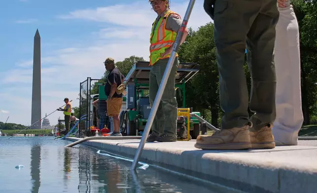 Members of the National Park Service clean the Lincoln Memorial Reflecting Pool of algae, Tuesday, June 16, 2026, in Washington. (AP Photo/Jacquelyn Martin)