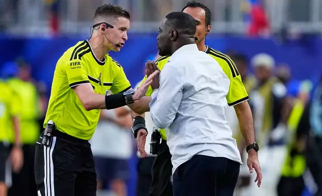 Referee Francois Letexier gestures to Ivory Coast head coach Emerse Fae during the World Cup Group E soccer match between Ivory Coast and Ecuador in Philadelphia, Sunday, June 14, 2026. (AP Photo/Petr David Josek)