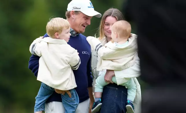 Bud Cauley, top left, of the United States, celebrates with his family on the 18th green after winning the Canadian Open golf tournament in Caledon, Ontario, Sunday June 14, 2026. (Frank Gunn/The Canadian Press via AP)