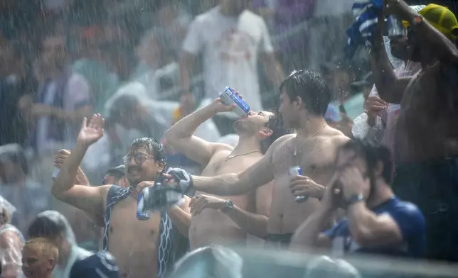 Fans react after a weather delay during the World Cup Group I soccer match between France and Iraq in Philadelphia, Monday, June 22, 2026. (AP Photo/Matt Rourke)