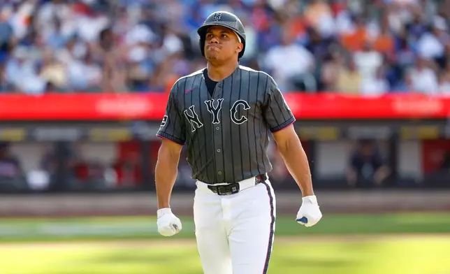 New York Mets' Juan Soto reacts after hitting a pop fly for an out during the sixth inning of a baseball game against the Atlanta Braves, Saturday, June 13, 2026, in New York. (AP Photo/Noah K. Murray)