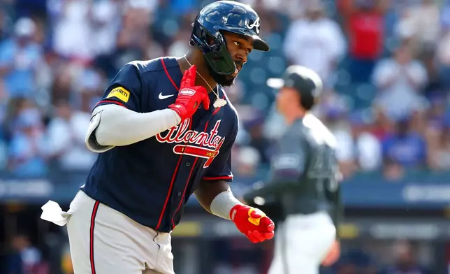 Atlanta Braves' Michael Harris II reacts rounding the bases after hitting a home run against the New York Mets during the eighth inning of a baseball game, Saturday, June 13, 2026, in New York. (AP Photo/Noah K. Murray)