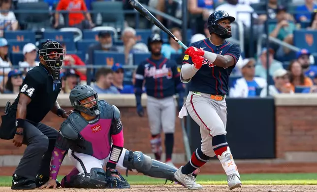 Atlanta Braves' Michael Harris II follows through on a home run during the eighth inning of a baseball game against the New York Mets, Saturday, June 13, 2026, in New York. (AP Photo/Noah K. Murray)