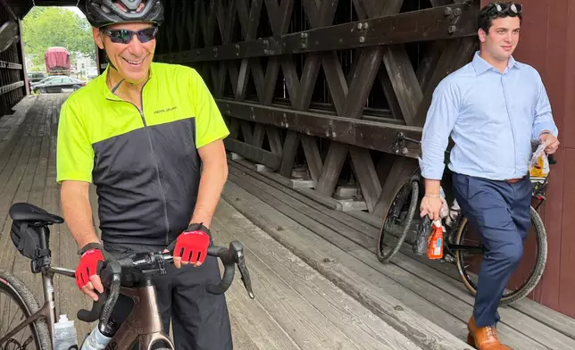 Rahm Emanuel takes a break from a bike ride through New Hampshire, Saturday, June 6, 2026. (AP Photo/Steven Sloan)