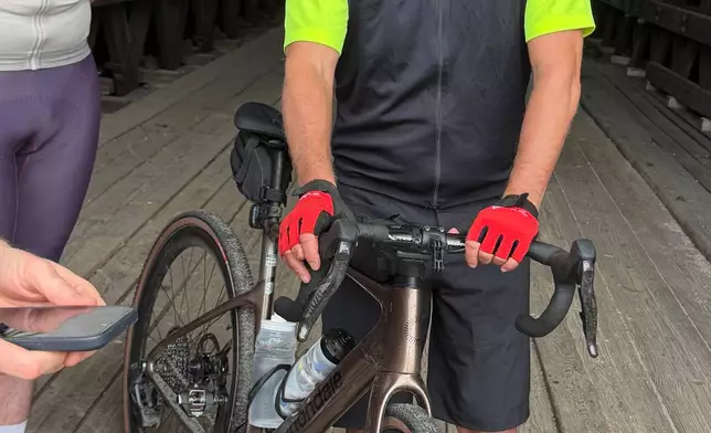 Rahm Emanuel takes a break from a bike ride through New Hampshire, Saturday, June 6, 2026. (AP Photo/Steven Sloan)