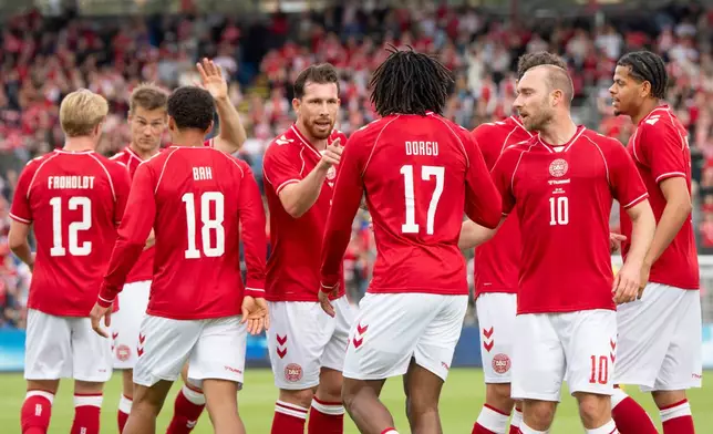 Denmark's players react after Patrick Dorgu scored against Ukraine during an international football match between Denmark and Ukraine, in Odense, Denmark, Sunday, June 7, 2026. Player Christian Eriksen (10) is second right. (Bo Amstrup/Ritzau Scanpix via AP)