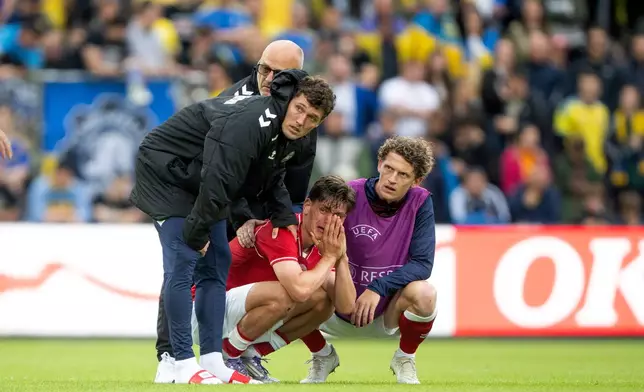 Denmark's Joakim Maehle, Andreas Christensen, and Jens Stage react after Christian Eriksen collapsed on the field during the international friendly soccer match between Denmark and Ukraine in Odense, Denmark, Sunday, June 7, 2026. (Bo Amstrup/Ritzau Scanpix via AP)