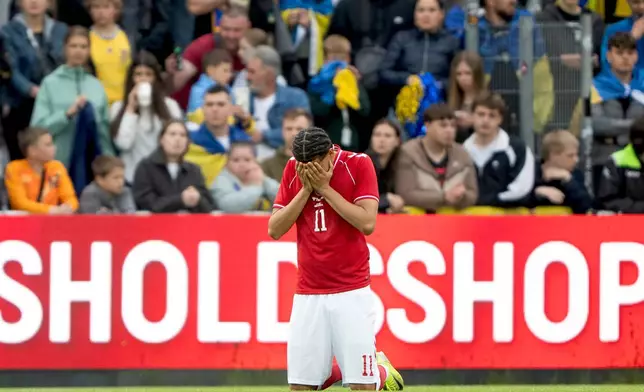 Denmark's William Osula reacts after Denmark's player Christian Eriksen collapsed on the field during the international friendly soccer match between Denmark and Ukraine in Odense, Denmark, Sunday, June 7, 2026. (Bo Amstrup/Ritzau Scanpix via AP)