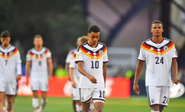 Germany's Jamal Musiala (10) and Malick Thiaw (24) walk off the field after losing to Paraguay in a shootout during the World Cup round of 32 soccer match in Foxborough, Mass., near Boston, Monday, June 29, 2026. (AP Photo/Steven Senne)