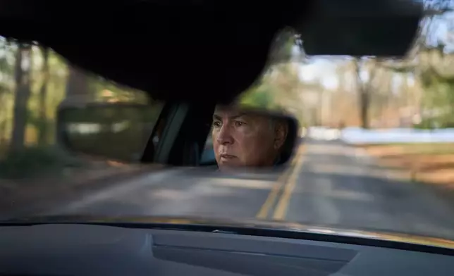 Chris Colocousis, whose retirement savings was targeted by a scammer, drives to a work meeting Wednesday, March 11, 2026, in Raynham, Mass. (AP Photo/David Goldman)